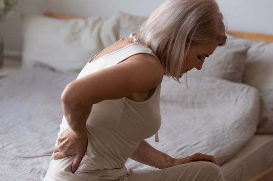 Woman With Stiff And Tight Muscles Result In Back Pain